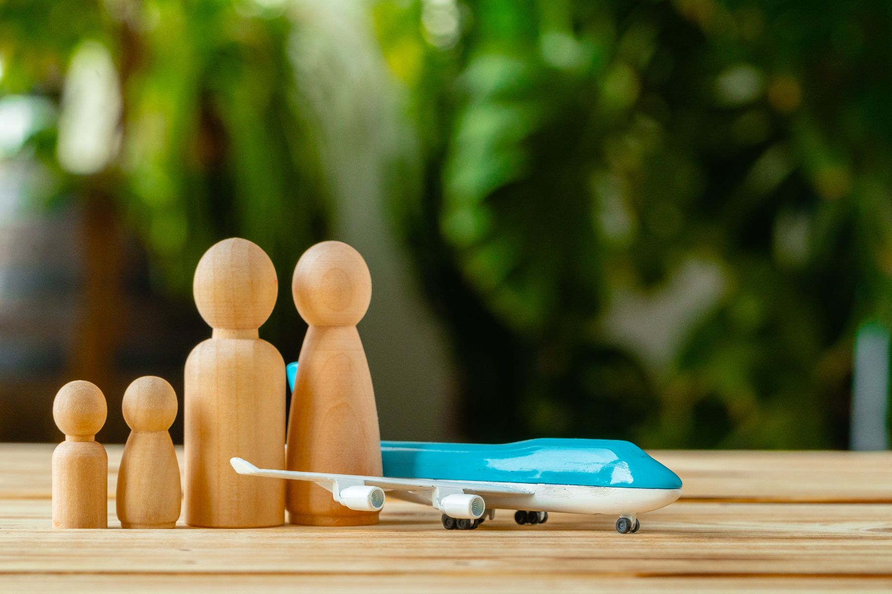 family-travel-and-vacation-concept-wooden-figures-2023-11-27-05-07-29-utc